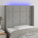 sengegavl med LED-lys 83x16x118/128 cm stof lysegrå