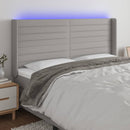 sengegavl med LED-lys 163x16x118/128 cm stof lysegrå